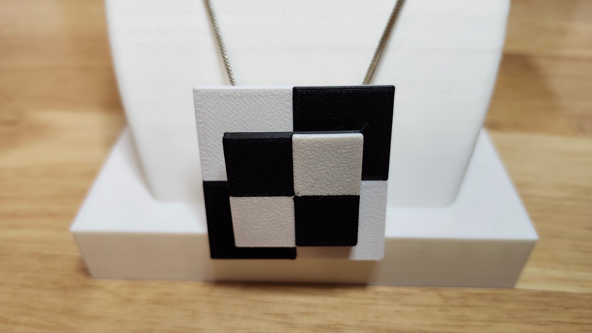 Necklace Adapter being used on a chain with a 2 Tone Check Print Base and a 2 Tone Check Print Brim