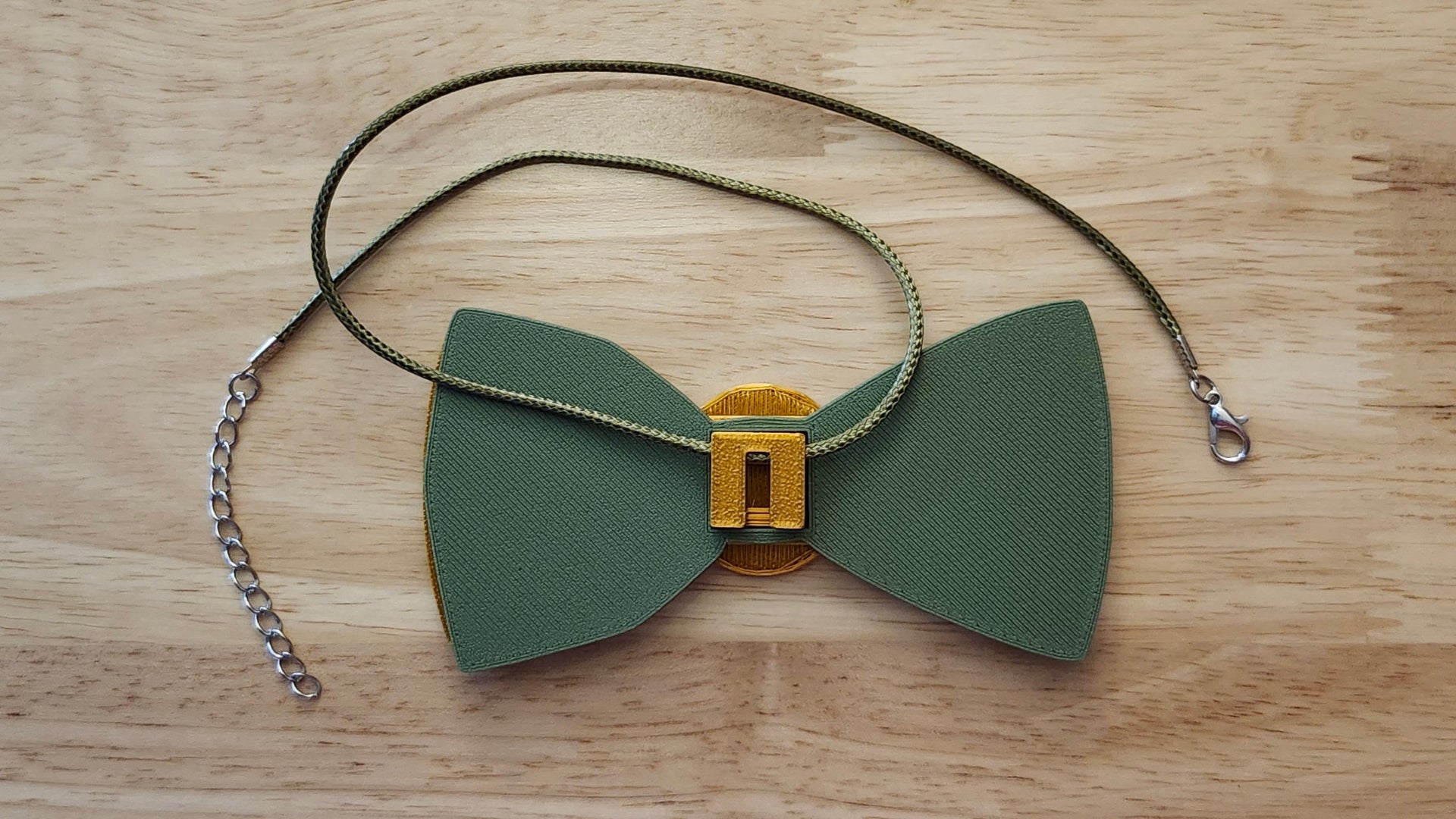 Money Bow Bundle Coin Button Cover, 100 Dollar Bill Bow, Gold Money Bow, reverse side shown to demonstrate how it is worn with the included necklace.  3D printed for use as a bow tie, button cover, necklace, pin, hat pin, lapel pin and so much more. 