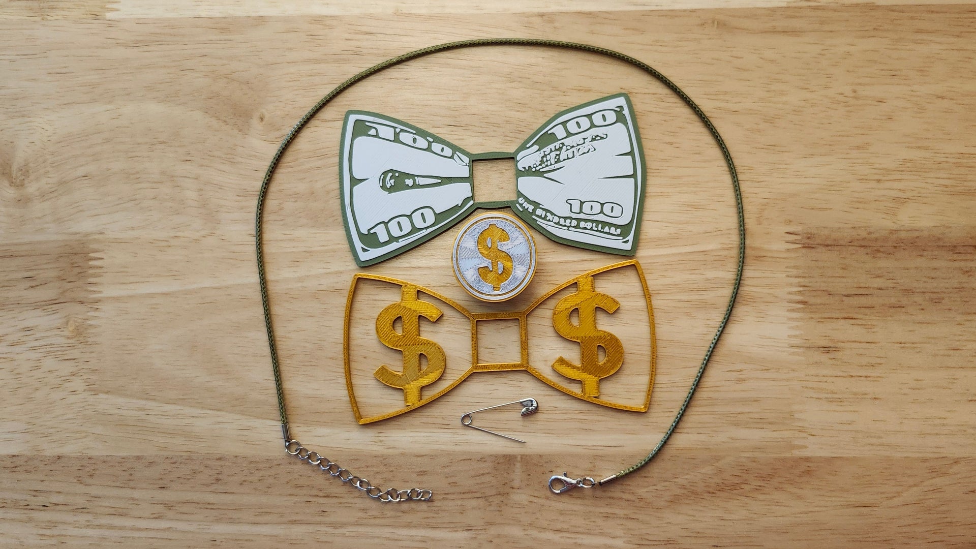 Money Bow Bundle including Coin Button Cover, 100 Dollar Bill Bow, Gold Money Bow, a safety pin and money green necklace. 3D printed for use as a bow tie, button cover, necklace, pin, hat pin, lapel pin and so much more. 