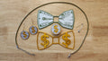 Money Bow Bundle including Coin Button Cover, 100 Dollar Bill Bow, Gold Money Bow, matching Coin Earrings, a safety pin and money green necklace. 3D printed for use as a bow tie, button cover, necklace, pin, hat pin, lapel pin and so much more. 