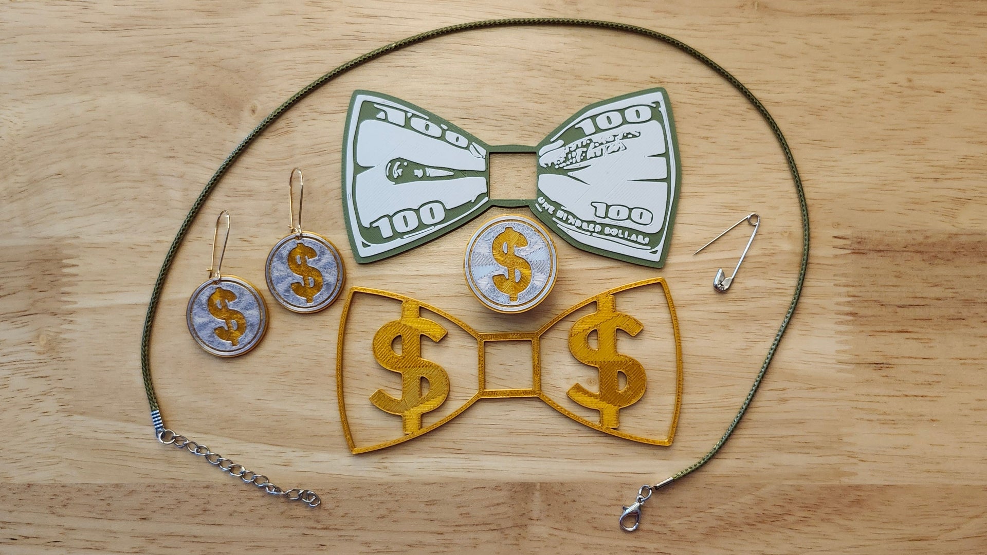Money Bow Bundle including Coin Button Cover, 100 Dollar Bill Bow, Gold Money Bow, matching Coin Earrings, a safety pin and money green necklace. 3D printed for use as a bow tie, button cover, necklace, pin, hat pin, lapel pin and so much more. 