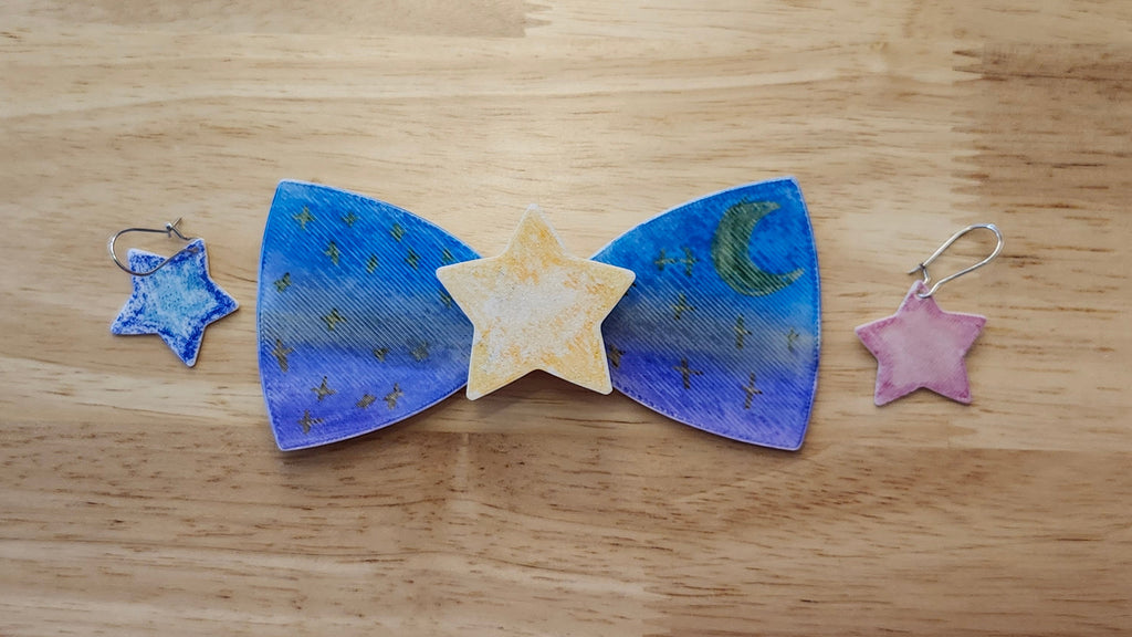 Bespoke It Yourself/Solid White Bow Bundle decorated sample including Star Button Cover and Blank Bow with matching star earrings. 3D printed then hand colored by the customer for use as a bow tie, button cover, necklace, pin, hat pin, lapel pin and so much more.