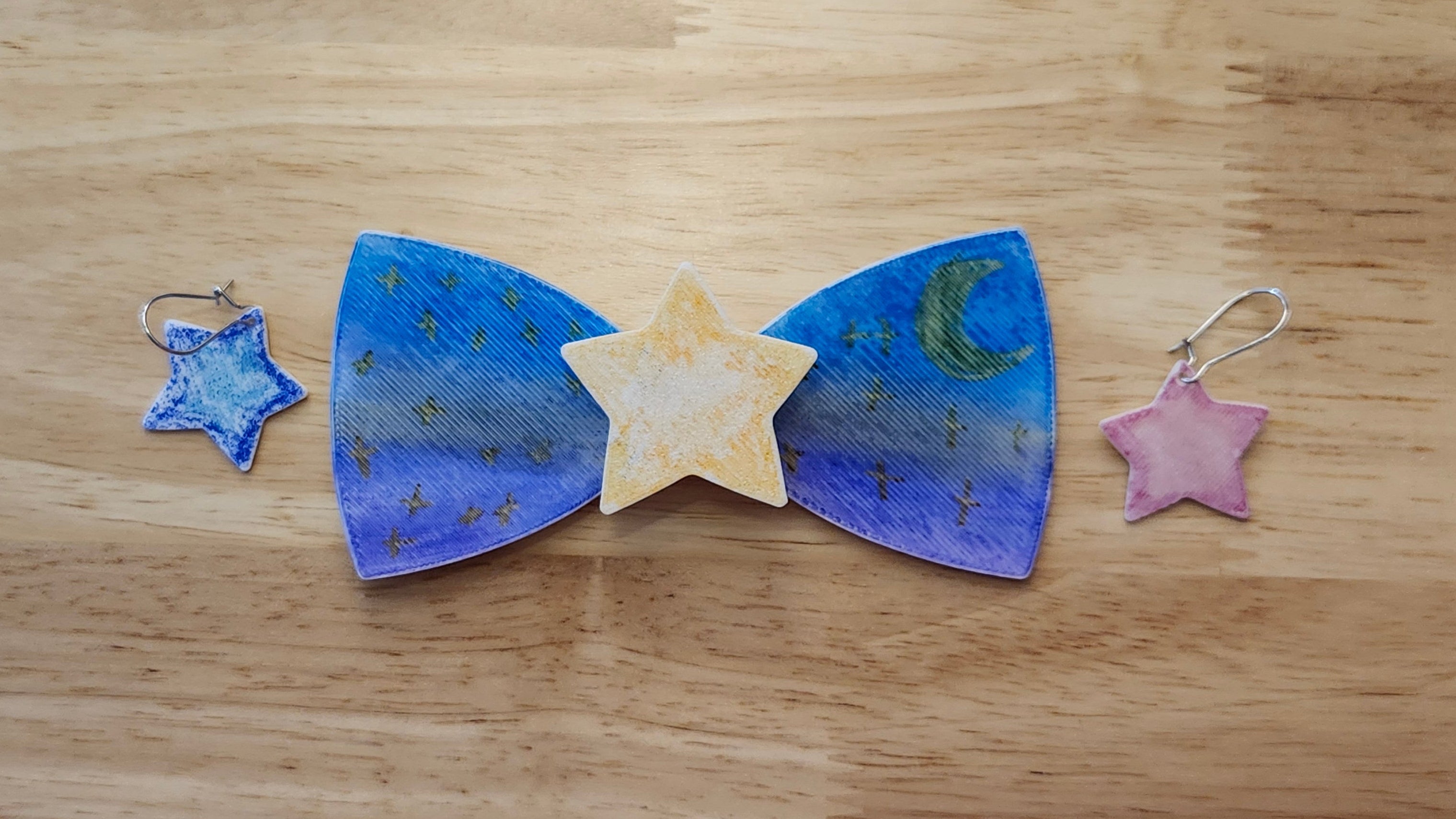 Bespoke It Yourself/Solid White Bow Bundle decorated sample including Star Button Cover and Blank Bow with matching star earrings. 3D printed then hand colored by the customer for use as a bow tie, button cover, necklace, pin, hat pin, lapel pin and so much more.