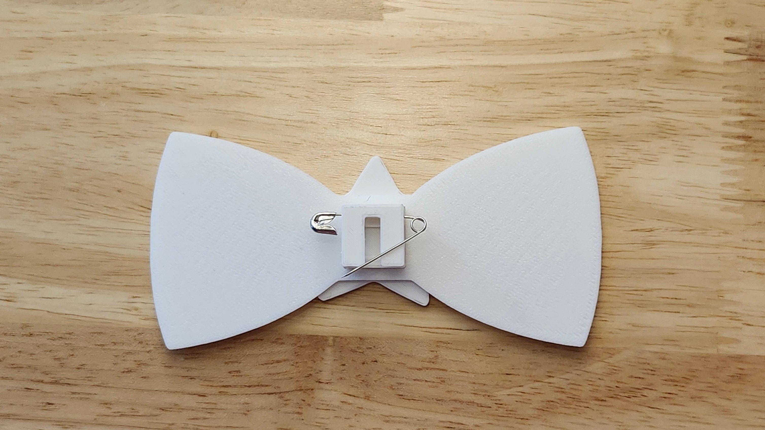 Bespoke It Yourself/Solid White Bow Bundle including Star Button Cover and Blank Bow reverse side shown to demonstrate how to turn it in to a pin with the included safety pin.  3D printed for use as a bow tie, button cover, necklace, pin, hat pin, lapel pin and so much more.