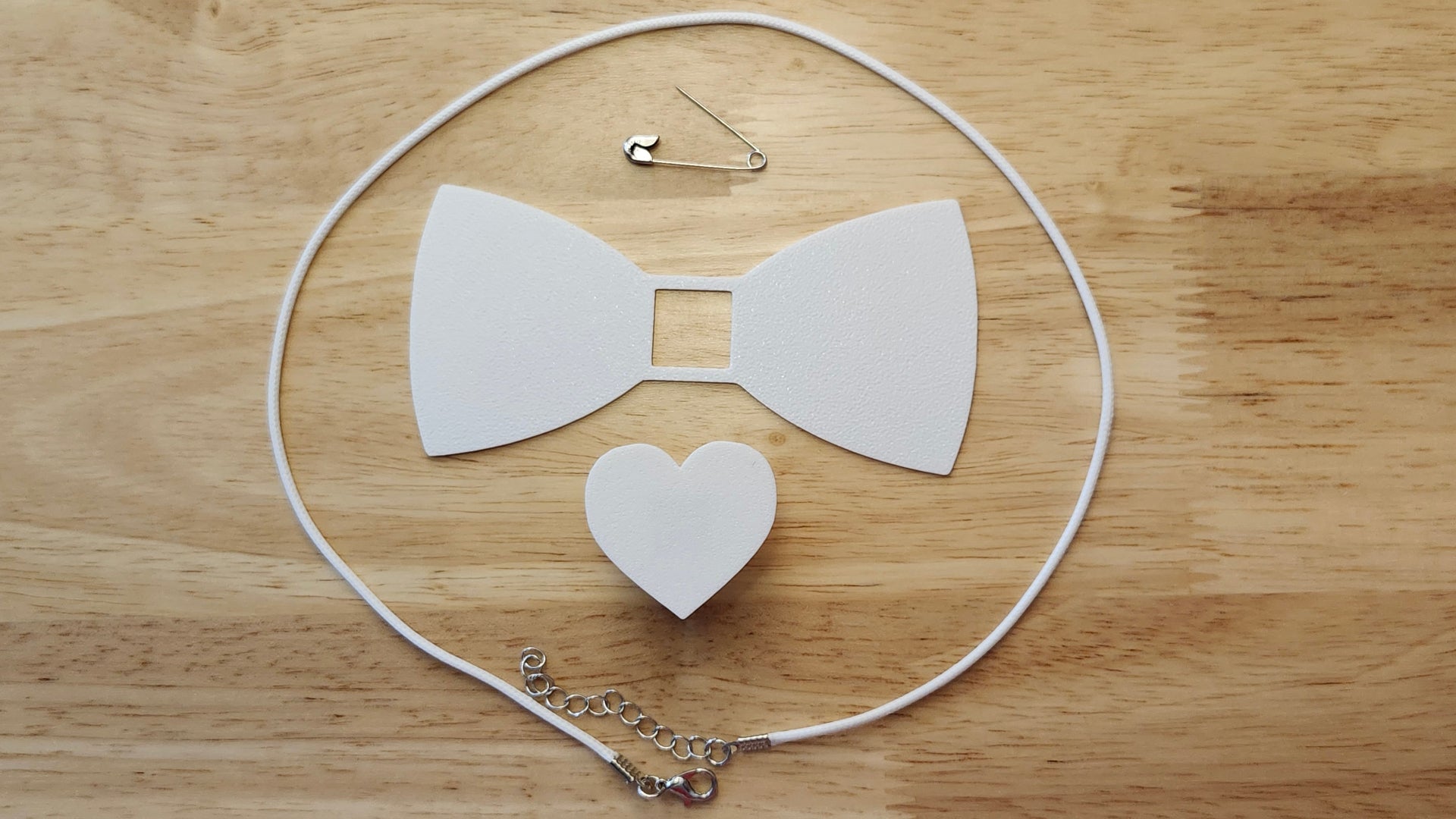 Bespoke It Yourself/Solid White Bow Bundle including Heart Button Cover and Blank Bow, a safety pin and white necklace. 3D printed for use as a bow tie, button cover, necklace, pin, hat pin, lapel pin and so much more. 