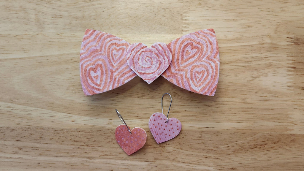 Bespoke It Yourself/Solid White Bow Bundle decorated sample including Heart Button Cover and Blank Bow with matching Heaert earrings. 3D printed then hand colored by the customer for use as a bow tie, button cover, necklace, pin, hat pin, lapel pin and so much more.