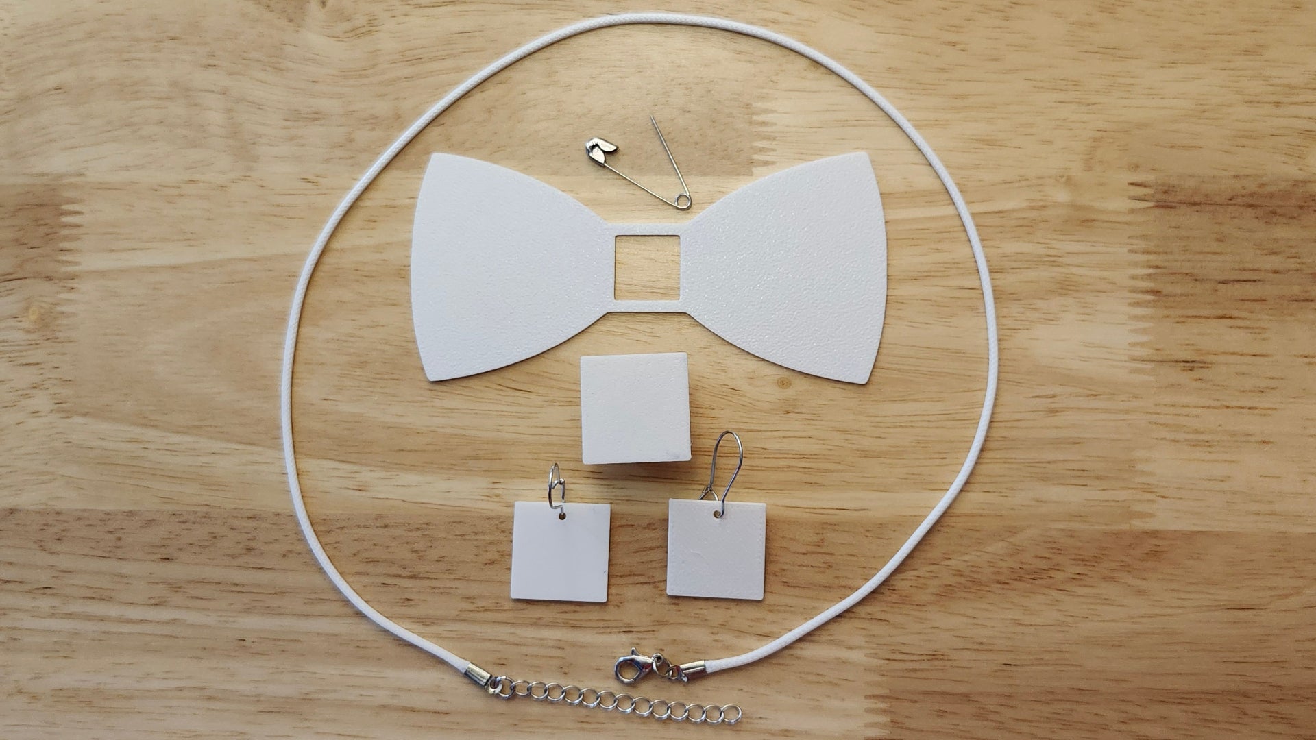 Bespoke It Yourself/Solid White Bow Bundle including Square Button Cover and Blank Bow, matching Square earrings, a safety pin and white necklace. 3D printed for use as a bow tie, button cover, necklace, pin, hat pin, lapel pin and so much more. 