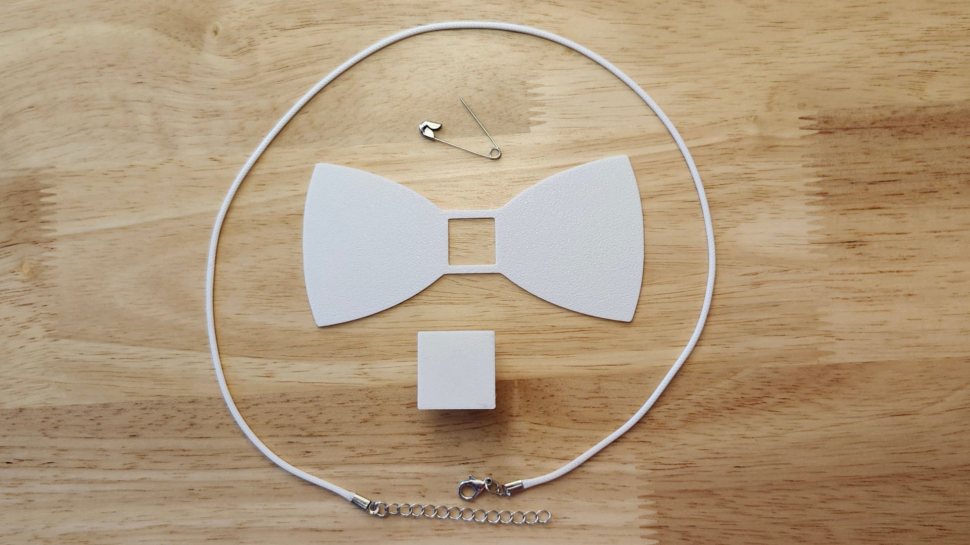 Bespoke It Yourself/Solid White Bow Bundle including Square Button Cover and Blank Bow, a safety pin and white necklace. 3D printed for use as a bow tie, button cover, necklace, pin, hat pin, lapel pin and so much more. 
