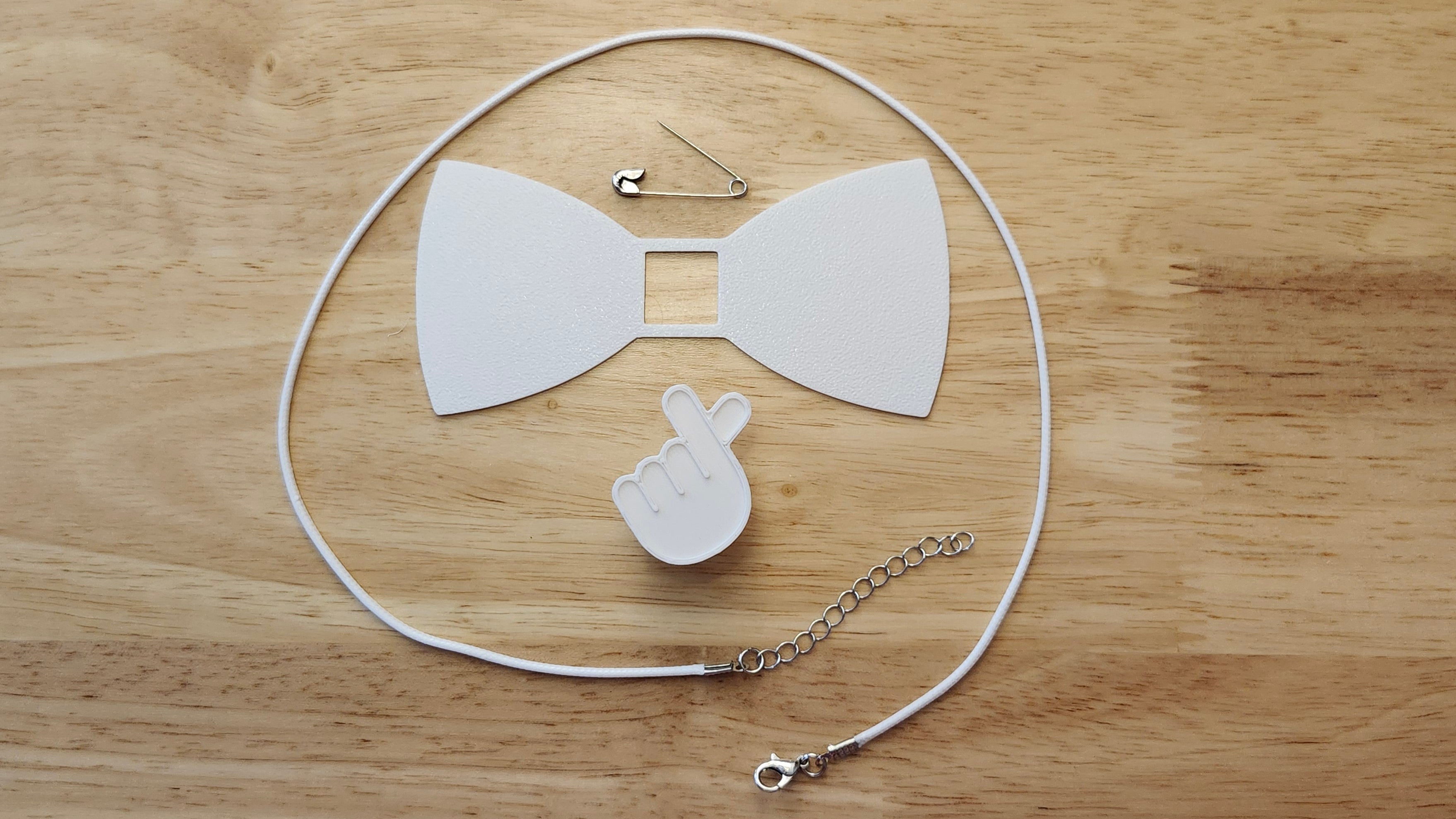 Bespoke It Yourself/Solid White Bow Bundle including K-pop/Hand Heart Button Cover and Blank Bow, a safety pin and white necklace. 3D printed for use as a bow tie, button cover, necklace, pin, hat pin, lapel pin and so much more. 
