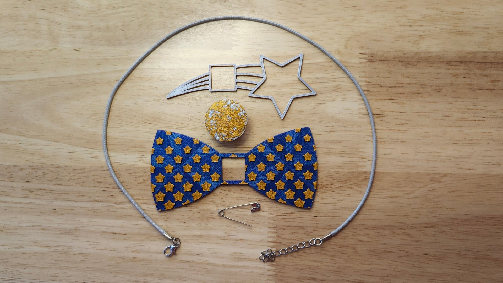Starry Night Bow Bundle including Moon Button Cover, Diminishing  Stars Bow, Shooting Star Back, a safety pin and silvery necklace. 3D printed for use as a bow tie, button cover, necklace, pin, hat pin, lapel pin and so much more. 