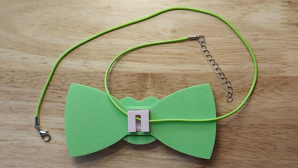 Lotus Flower Button Cover, Lotus Bow, and Lily Pad Back reverse side shown to demonstrate how it is worn with the included necklace. 