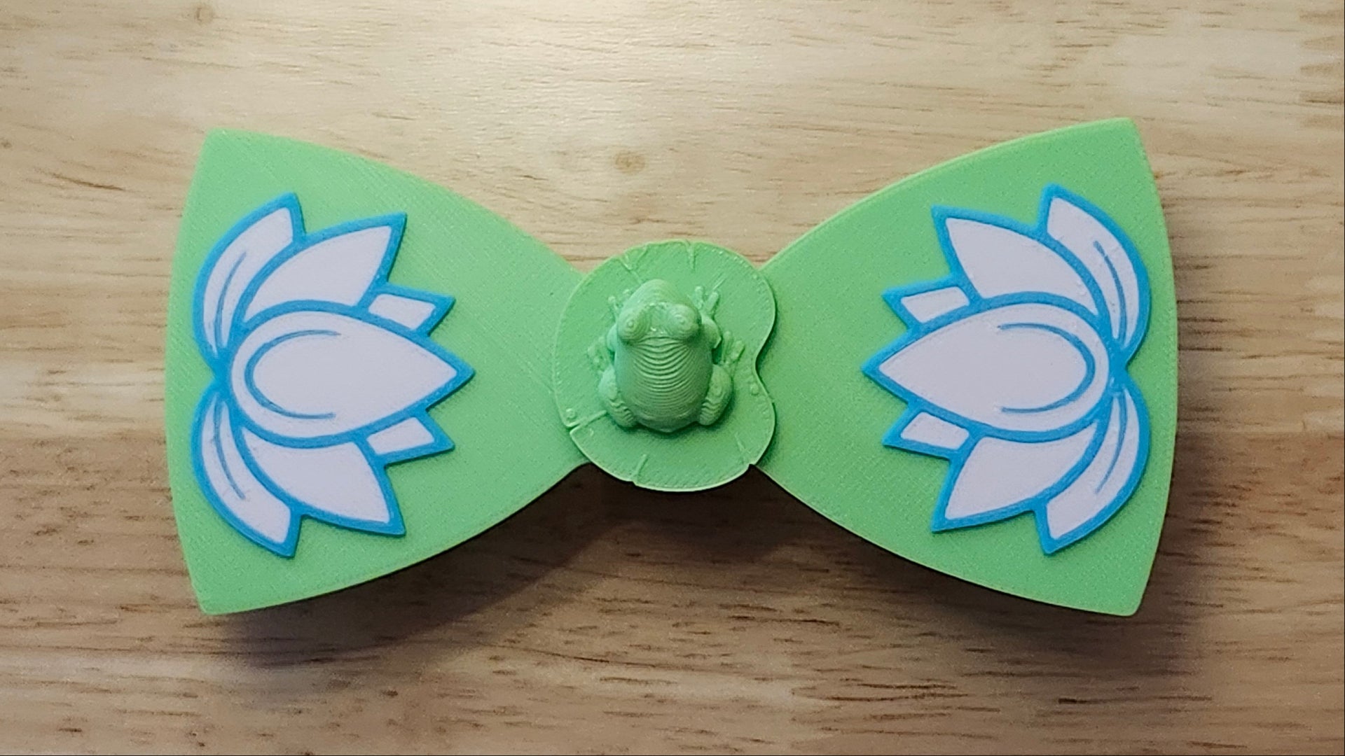 Frog Button Cover with Lotus Bow. 3D printed for use as a bow tie, button cover, necklace, pin, hat pin, lapel pin and so much more. 