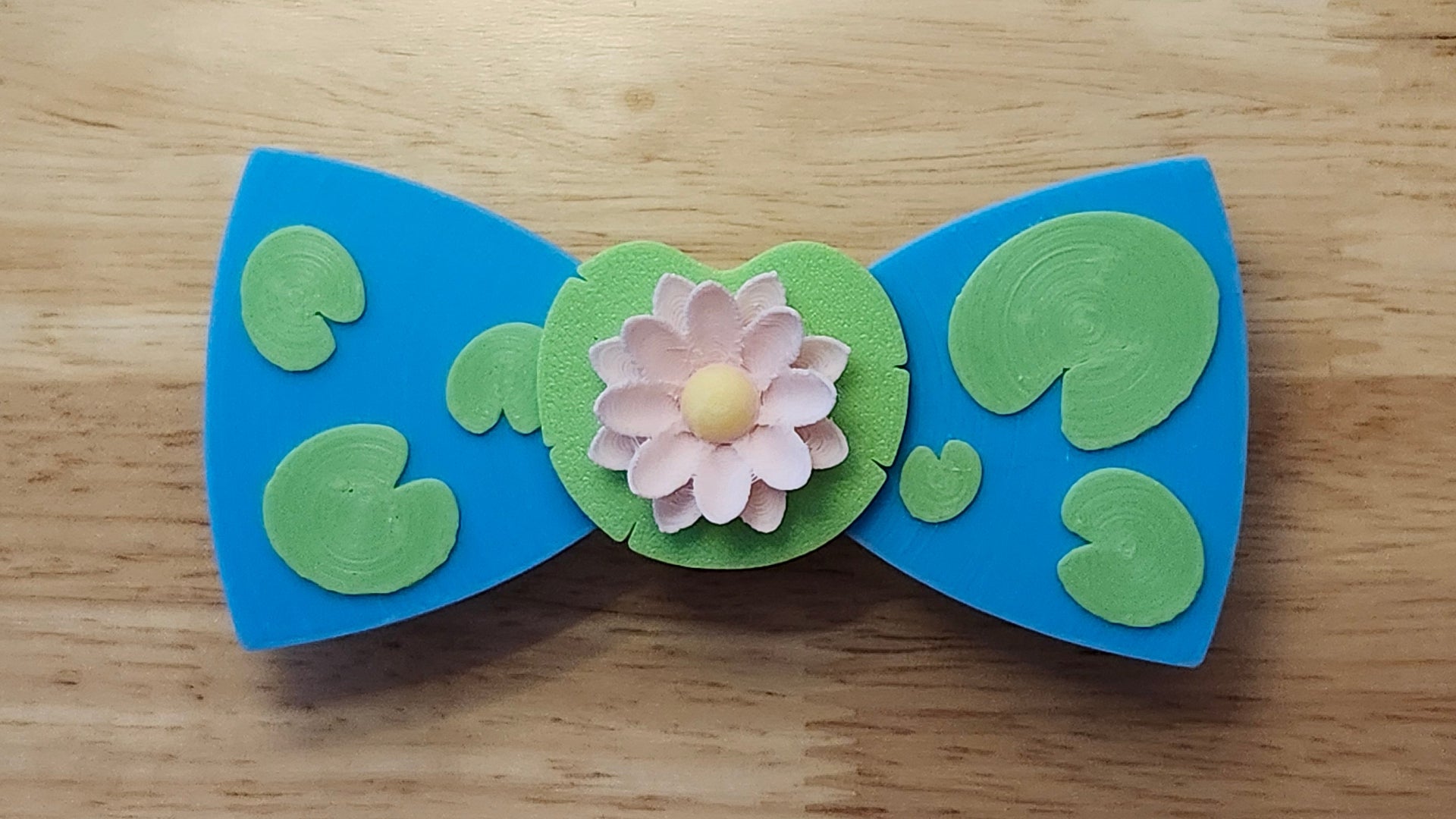 Lotus Flower Button Cover with Lily Pad Bow, and Lily Pad Back. 3D printed for use as a bow tie, button cover, necklace, pin, hat pin, lapel pin and so much more. 