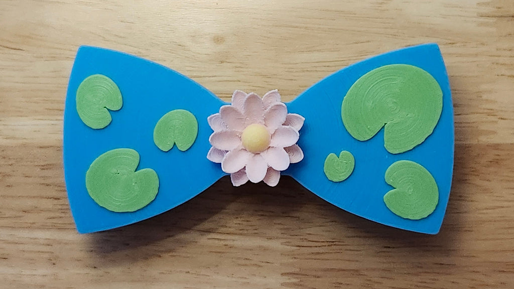 Lotus Flower Button Cover with Lily Pad Bow. 3D printed for use as a bow tie, button cover, necklace, pin, hat pin, lapel pin and so much more. 