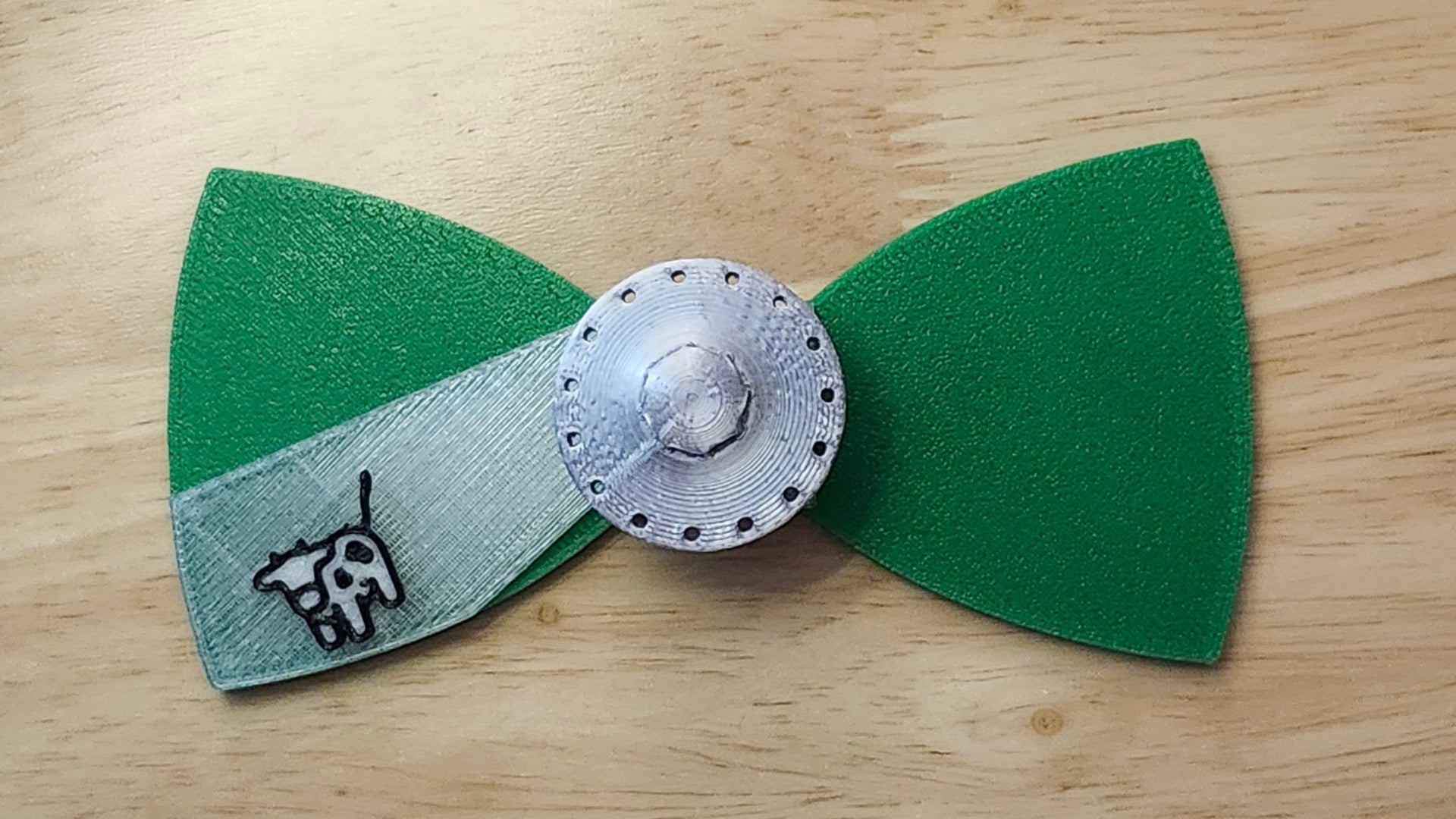 UFO Button Cover with Alien Head Bow (reverse side shown) and Cow Beaming Back. 3D printed for use as a bow tie, button cover, necklace, pin, hat pin, lapel pin and so much more.