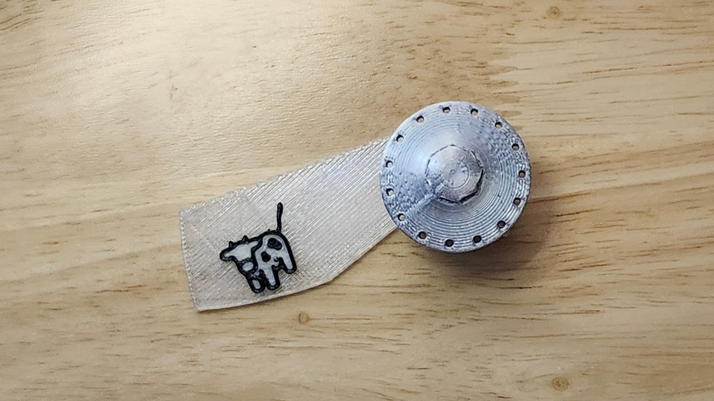 UFO Button Cover with Cow Beaming Back. 3D printed for use as a bow tie, button cover, necklace, pin, hat pin, lapel pin and so much more.