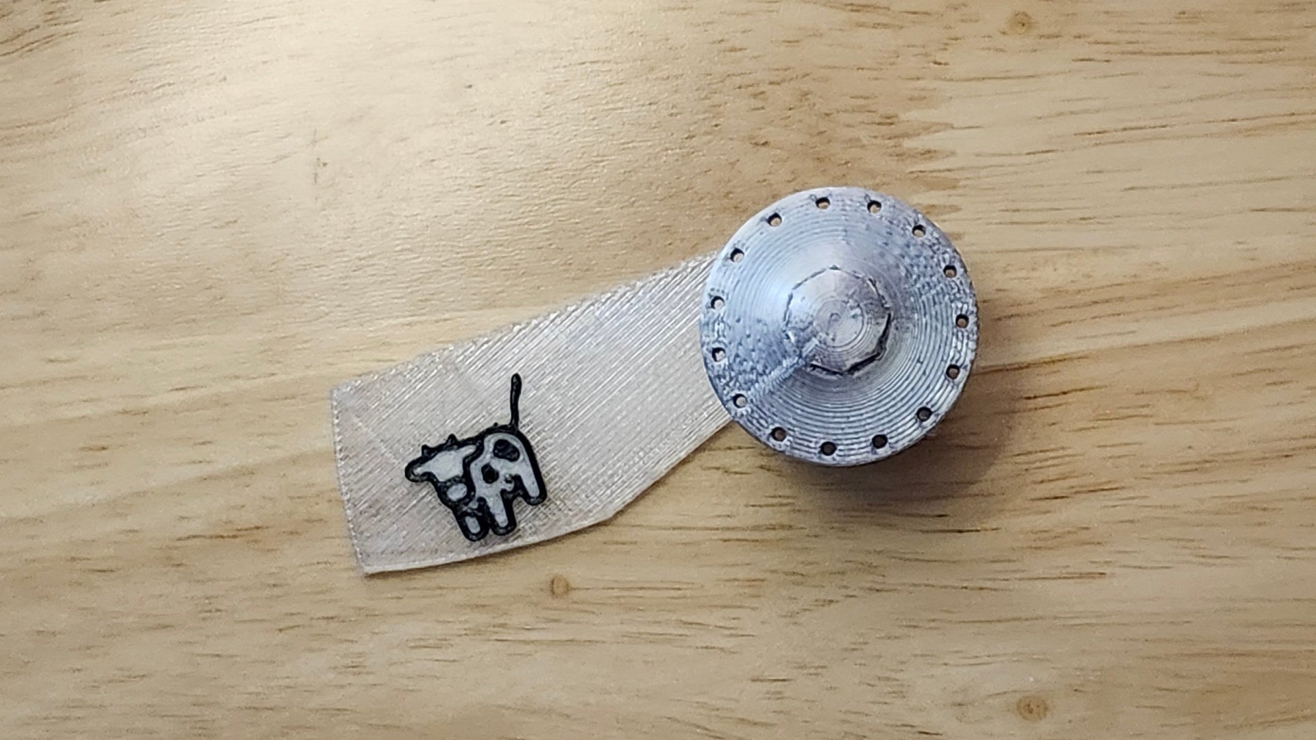 UFO Button Cover with Cow Beaming Back. 3D printed for use as a bow tie, button cover, necklace, pin, hat pin, lapel pin and so much more.