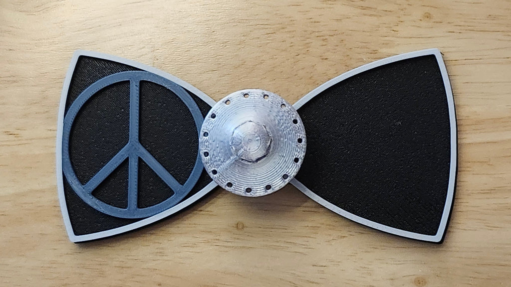 UFO Button Cover with Alien Peace Hand Bow (reverse side shown) and Peace Sign Bow (two tone side). 3D printed for use as a bow tie, button cover, necklace, pin, hat pin, lapel pin and so much more.