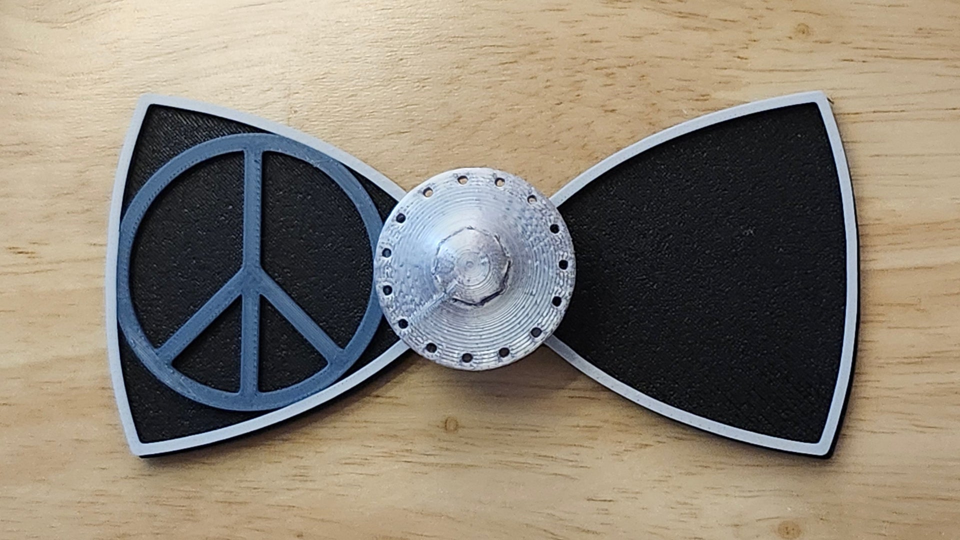 UFO Button Cover with Alien Peace Hand Bow (reverse side shown) and Peace Sign Bow (two tone side). 3D printed for use as a bow tie, button cover, necklace, pin, hat pin, lapel pin and so much more.