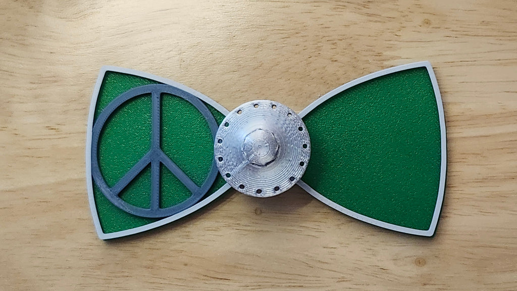 UFO Button Cover and Peace Sign Bow (two tone side) with Alien Head Bow (reverse side). 3D printed for use as a bow tie, button cover, necklace, pin, hat pin, lapel pin and so much more.