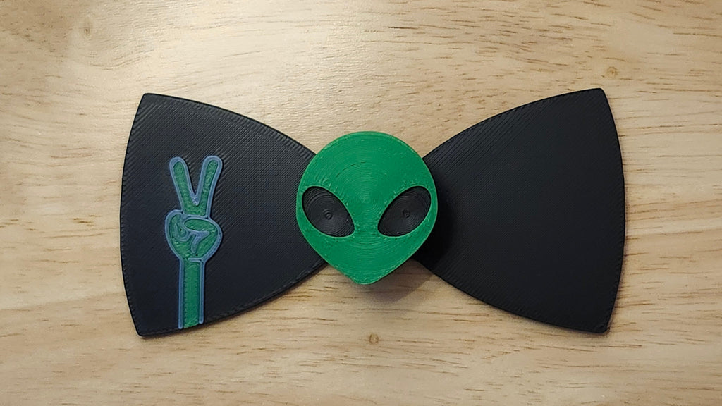 Alien Head Button Cover with Alien Peace Hand Bow. 3D printed for use as a bow tie, button cover, necklace, pin, hat pin, lapel pin and so much more.