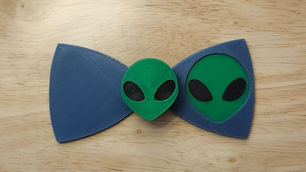 Alien Head Button Cover with Alien Head Bow. 3D printed for use as a bow tie, button cover, necklace, pin, hat pin, lapel pin and so much more.
