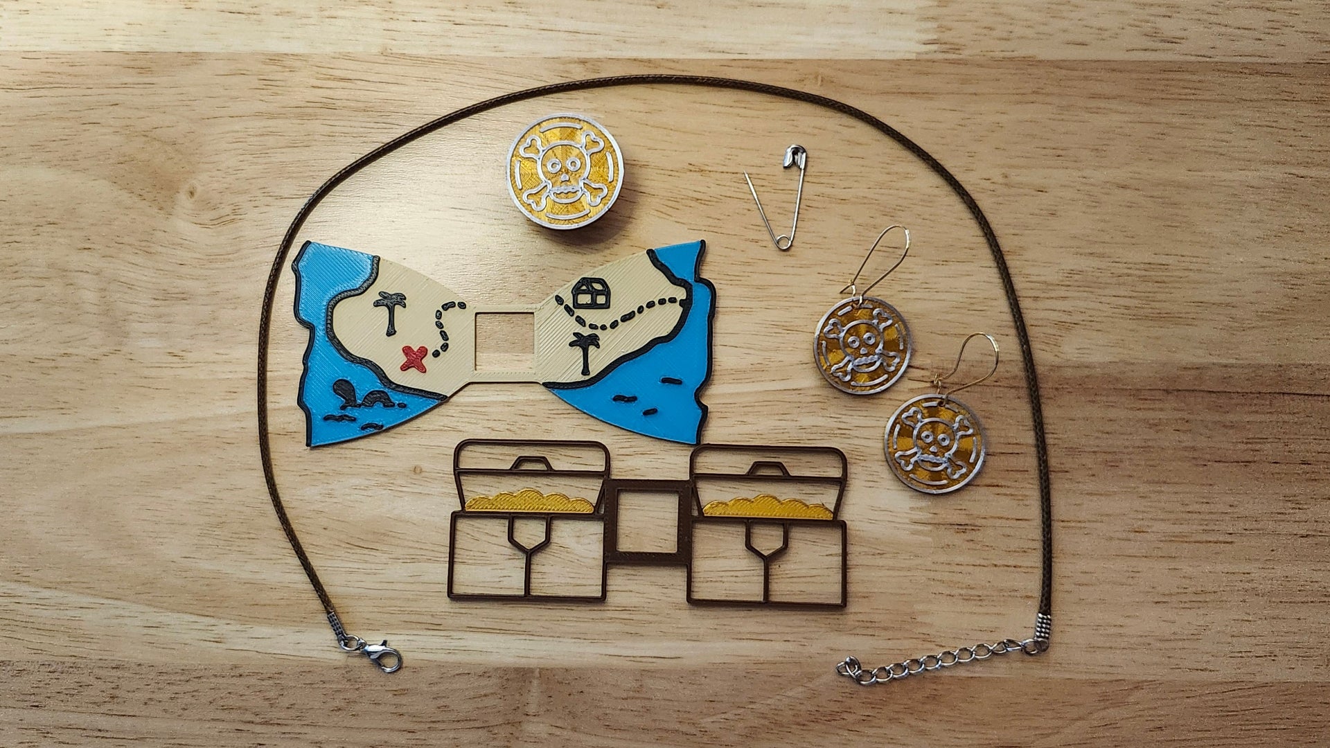 Treasure Hunt Bundle including the Doubloon Button Cover, Treasure Map Bow, Treasure Chest Back, matching Doubloon earrings, a safety pin and an 18 inch brown necklace. 3D printed for use as a bow tie, button cover, necklace, pin, hat pin, lapel pin and so much more.