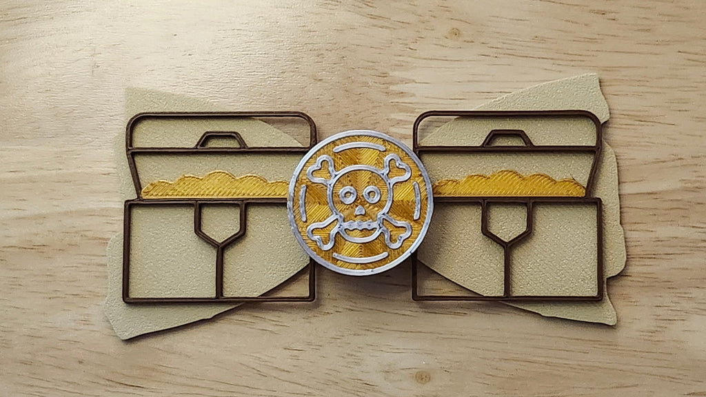 Doubloon Button Cover with Treasure Map Bow (reverse side shown) and Treasure Chest Back. 3D printed for use as a bow tie, button cover, necklace, pin, hat pin, lapel pin and so much more.