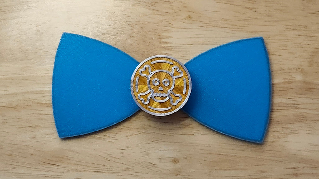 Doubloon Button Cover with Ship Bow (reverse side shown). 3D printed for use as a bow tie, button cover, necklace, pin, hat pin, lapel pin and so much more.