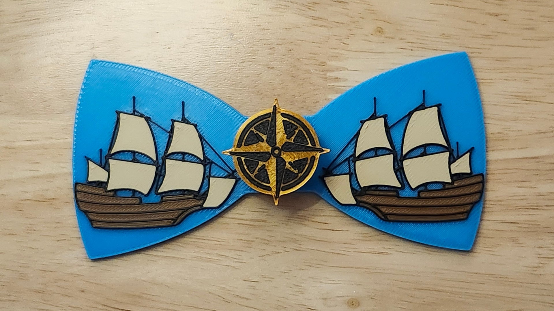 Compass Button Cover with Ship Bow. 3D printed for use as a bow tie, button cover, necklace, pin, hat pin, lapel pin and so much more.