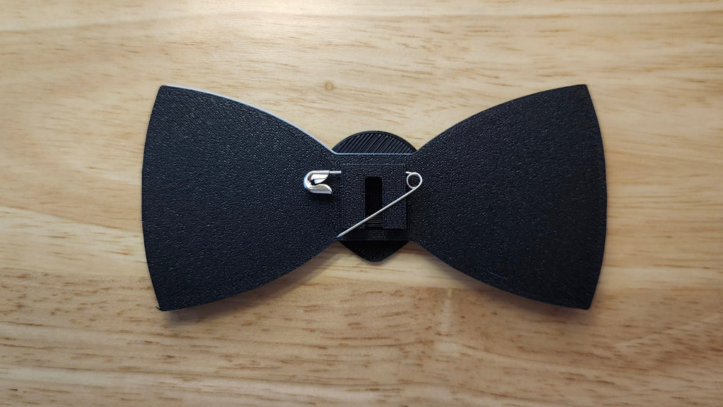 Head Button Cover with Alien Peace Hand Bow reverse side shown to demonstrate how to turn it in to a pin with the included safety pin. 