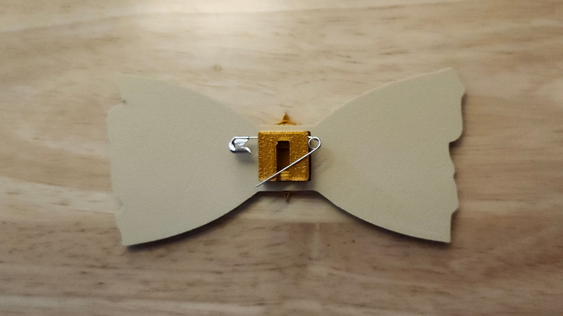 Compass Button Cover with Treasure Map Bow reverse side shown to demonstrate how to turn it in to a pin with the included safety pin.  
