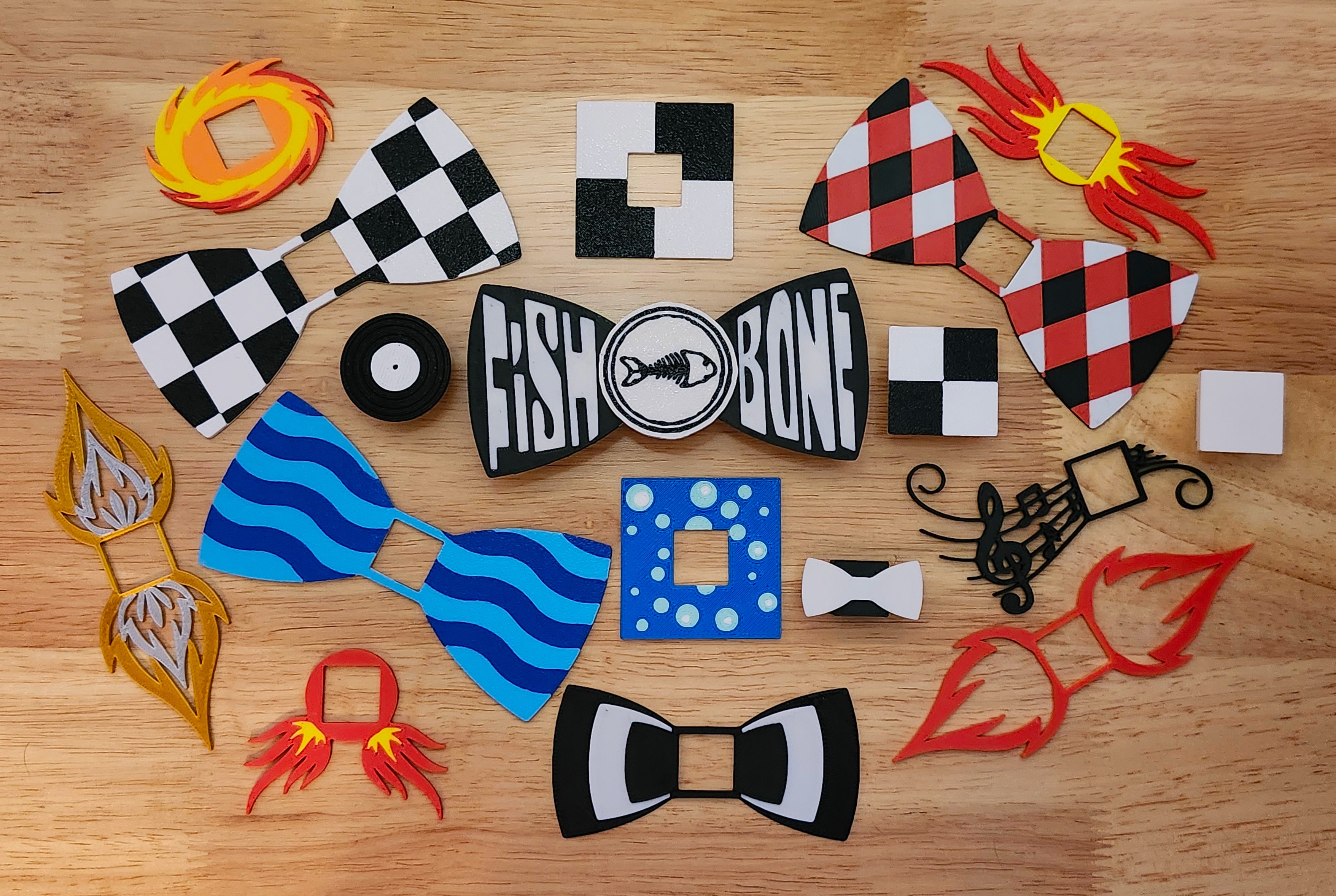 Collection of various bow tie designs on a wooden surface